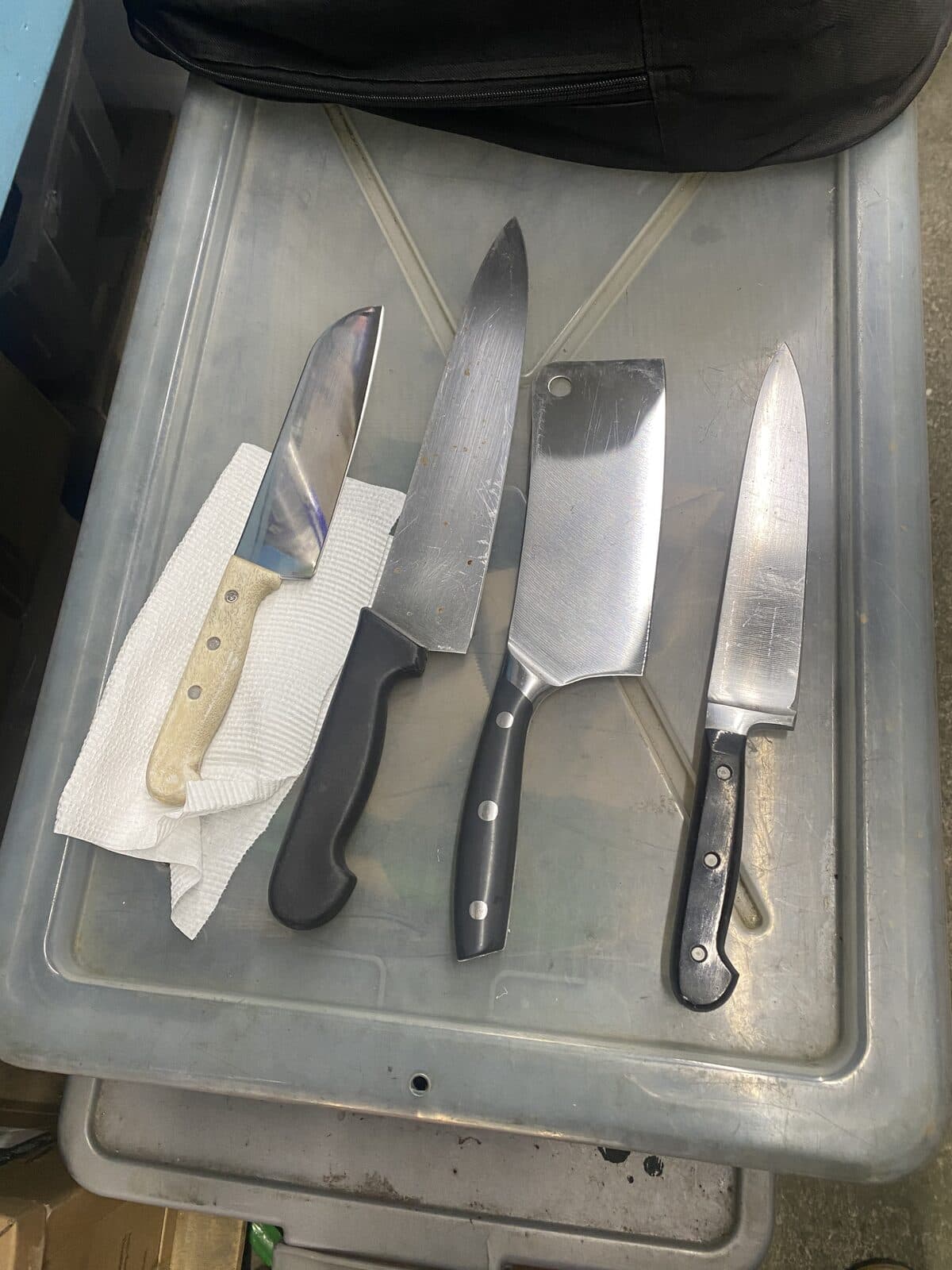 Chef and utility knives arranged for sharpening.