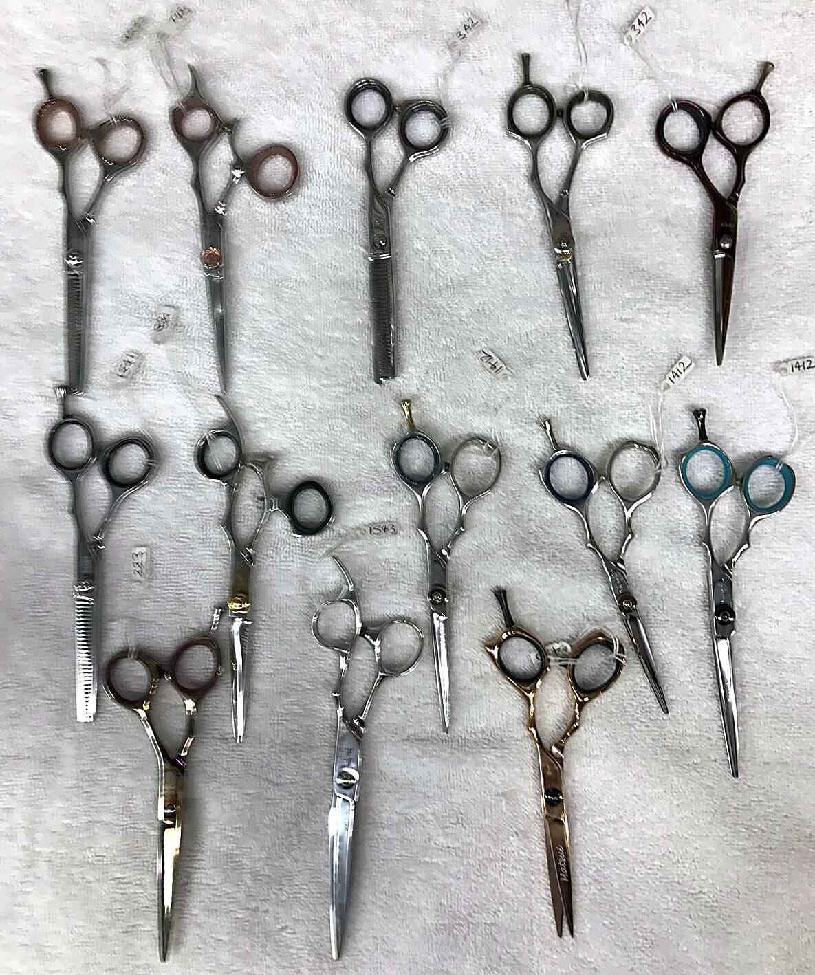 Collection of hairdressing scissors prepared for sharpening.